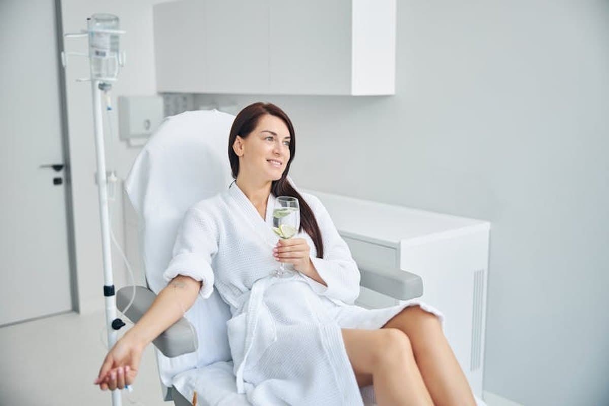 Client relaxing during an IV vitamin drip session